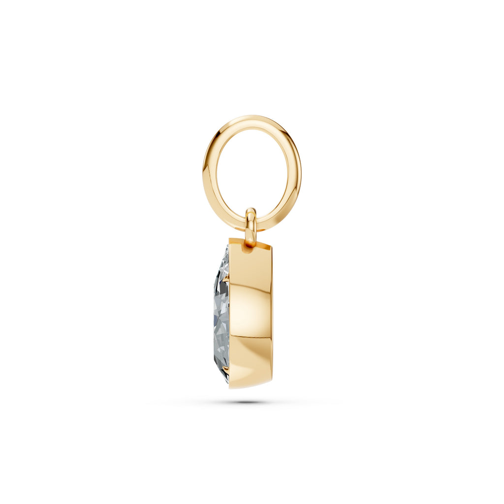 Gold pendant with a diamond on a white background